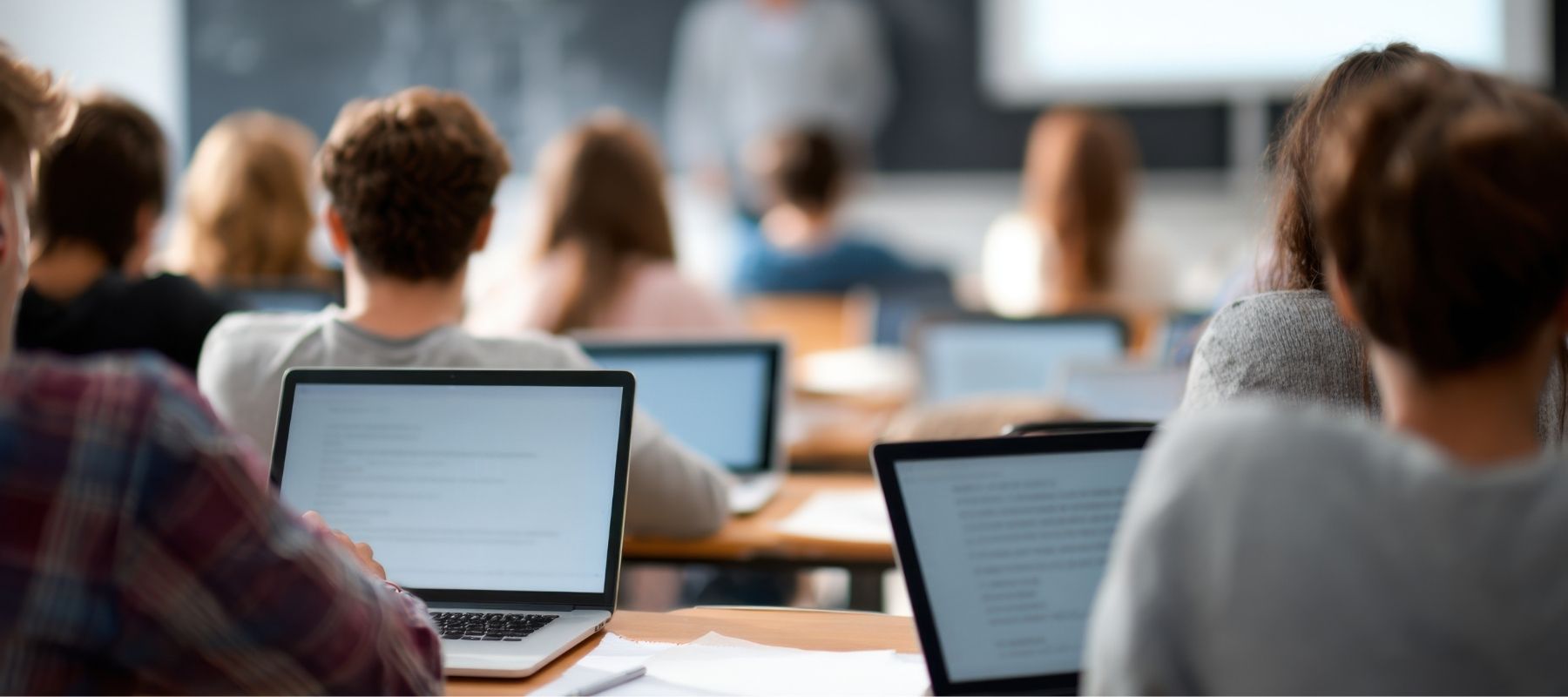 students using laptops in the classroom